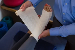 doctor bandaging foot injury